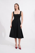 Load image into Gallery viewer, Woman wearing a black sleeveless dress on a white background