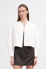 Load image into Gallery viewer, Woman wearing a white jacket and black skirt on a white background