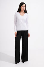 Load image into Gallery viewer, Woman wearing a white long-sleeve top and black wide-leg pants on a white background