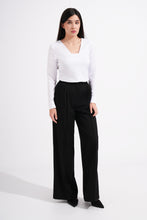 Load image into Gallery viewer, Woman wearing a white blouse and black pants on a white background