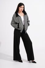 Load image into Gallery viewer, Woman wearing a patterned jacket and black pants on a white background