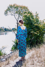 Load image into Gallery viewer, A colorful summer dress featuring maxi length, high front slit, and kimono style. - v-neckline - long puffy sleeves - fabric belt with tassels - shift silhouette - kimono style - maxi length