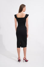 Load image into Gallery viewer, Woman wearing a black dress with a slit on a white background

