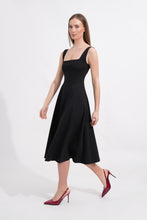 Load image into Gallery viewer, Woman wearing a black dress with a plain white background

