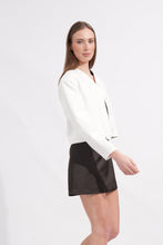 Load image into Gallery viewer, Woman wearing a white blouse and black skirt on a white background
