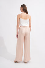 Load image into Gallery viewer, Woman wearing a white top and beige wide-leg pants on a white background
