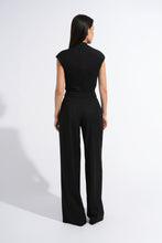 Load image into Gallery viewer, A woman viewed from the back wearing a black sleeveless top and black wide-leg trousers against a plain white studio background.
