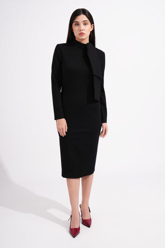 Woman wearing a black outfit with a high neck bow