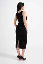 Load image into Gallery viewer, Woman wearing a black sleeveless dress with a slit on a white background
