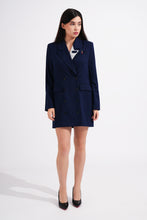 Load image into Gallery viewer, Woman wearing a navy blue blazer with a red pin on a white background
