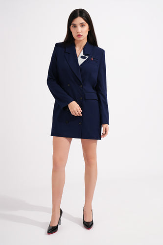 Woman wearing a navy blue blazer dress on a white background