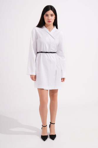 Woman wearing a white dress with a black belt on a white background
