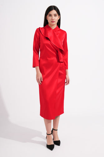 Woman wearing a red dress with a draped collar on a white background