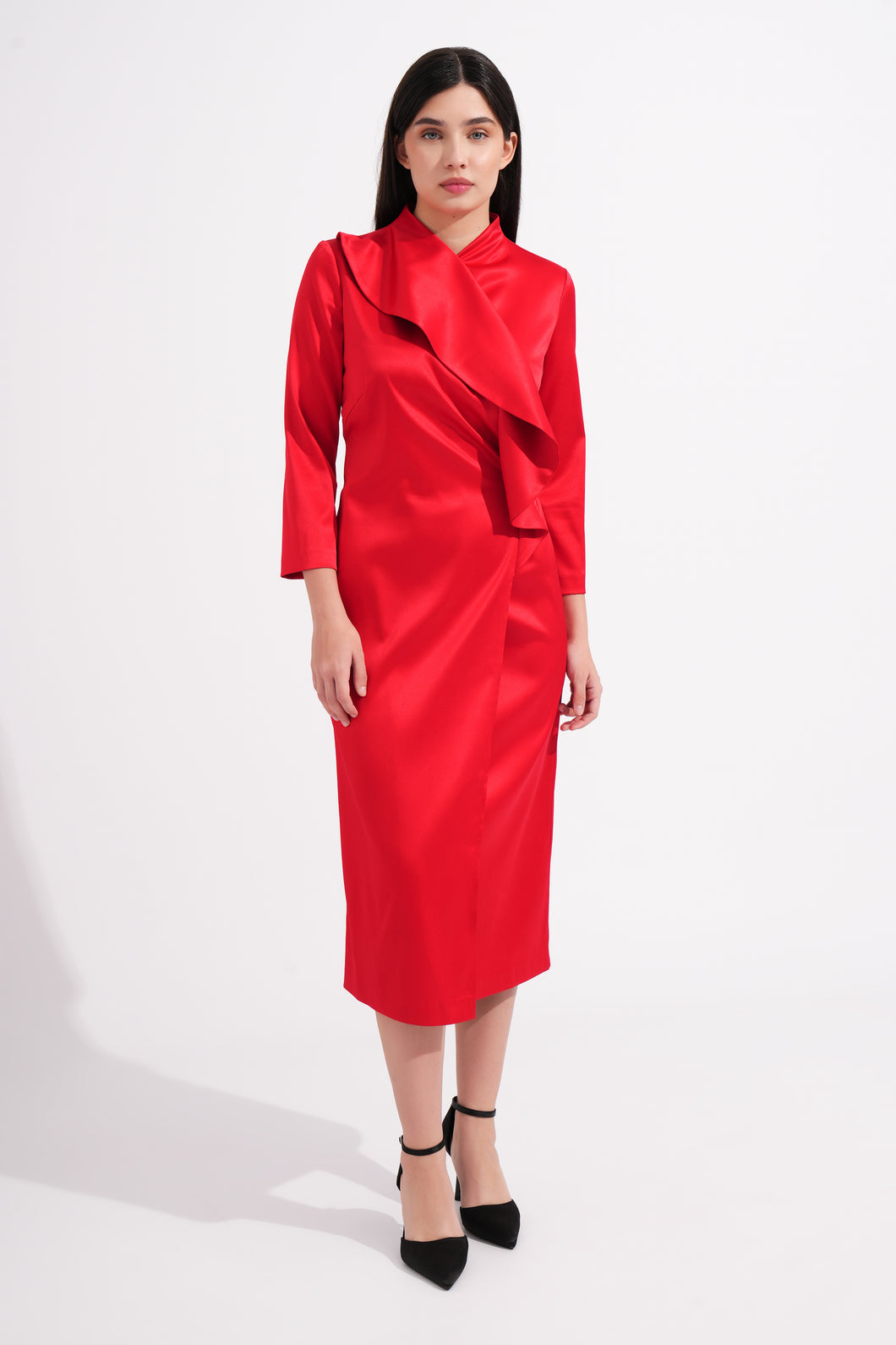 Woman wearing a red dress with a draped collar on a white background