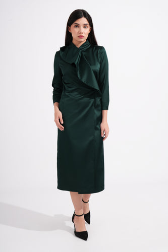 Woman wearing a green dress with a bow detail on a white background
