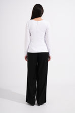Load image into Gallery viewer, Person wearing a white long-sleeve top and black pants on a white background
