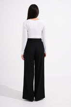 Load image into Gallery viewer, Person wearing a white shirt and black wide-leg pants on a white background
