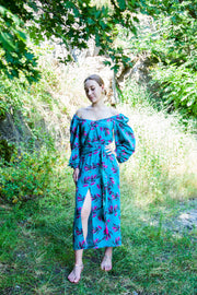 A colorful summer dress featuring maxi length, high front slit, and kimono style. - v-neckline&nbsp; - long puffy sleeves - fabric belt with tassels - shift silhouette - kimono style - maxi length