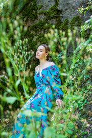 A colorful summer dress featuring maxi length, high front slit, and kimono style. - v-neckline&nbsp; - long puffy sleeves - fabric belt with tassels - shift silhouette - kimono style - maxi length