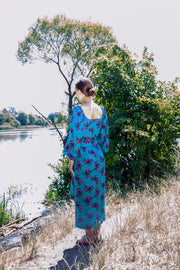 A colorful summer dress featuring maxi length, high front slit, and kimono style. - v-neckline&nbsp; - long puffy sleeves - fabric belt with tassels - shift silhouette - kimono style - maxi length